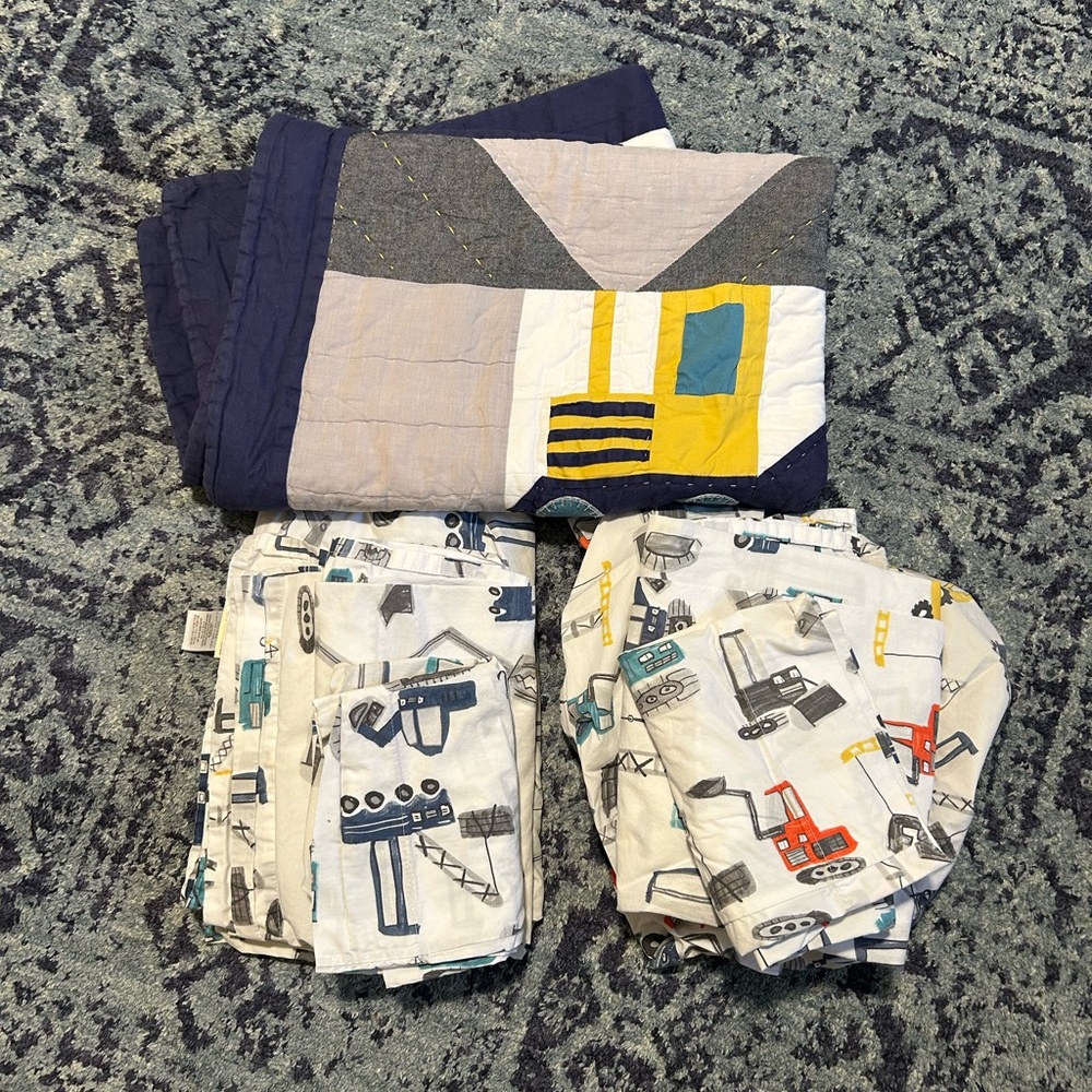 Pottery barn Jax construction toddler quilt + two sets of sheets + pillowcases.